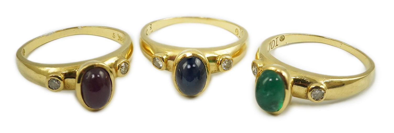 A suite of three modern 18k gold and gem set rings